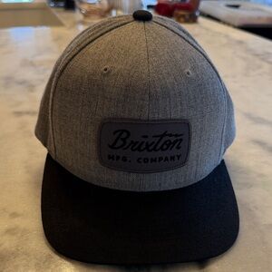 Brixton Jolt Snapback hat featuring a heather grey crown and a black brim.